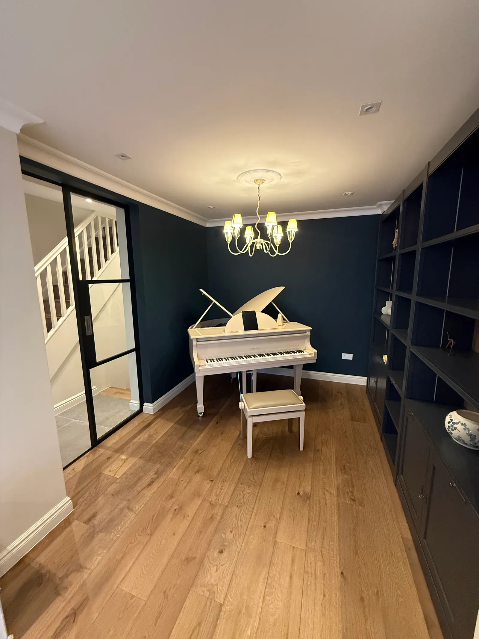 Period living room with restored detailing and bespoke shelves