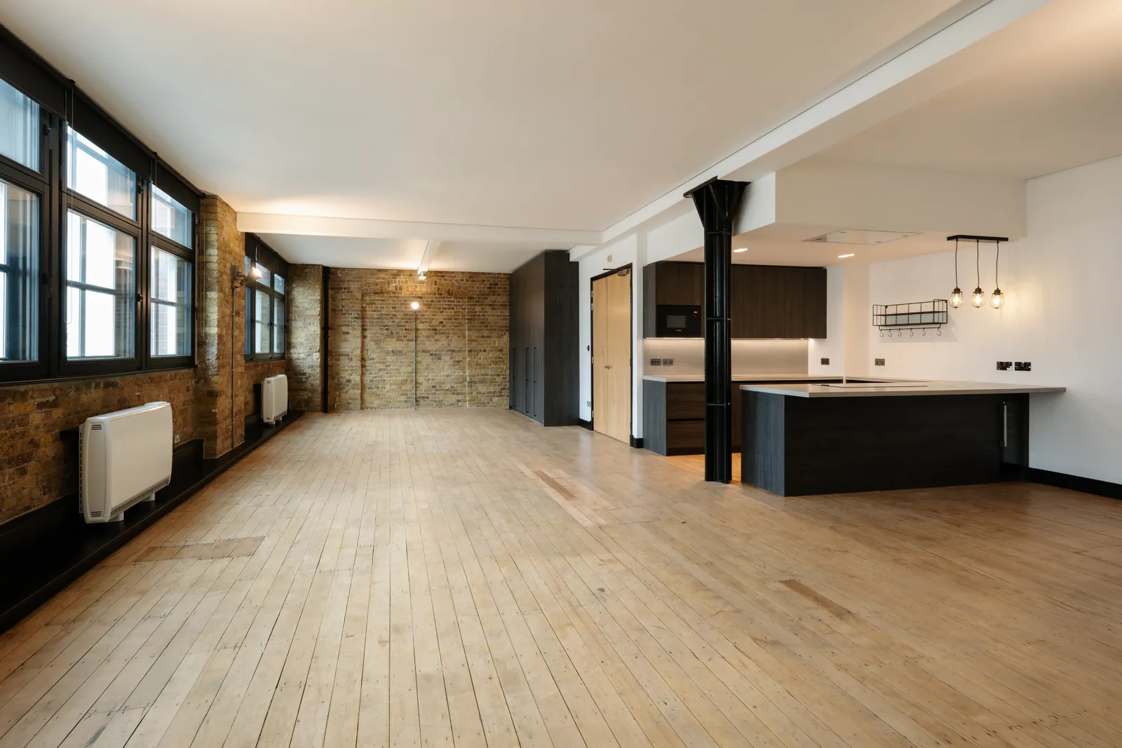 Refurbished open-plan living space with exposed brickwork